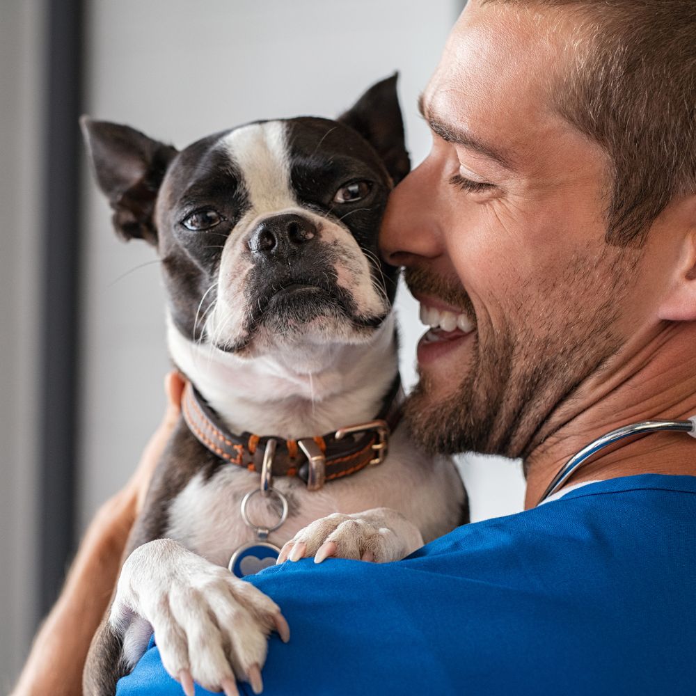 Man smiling, holding dog. Man smiling, holding dog.